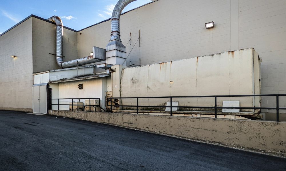 large trash compactor external to large commercial building